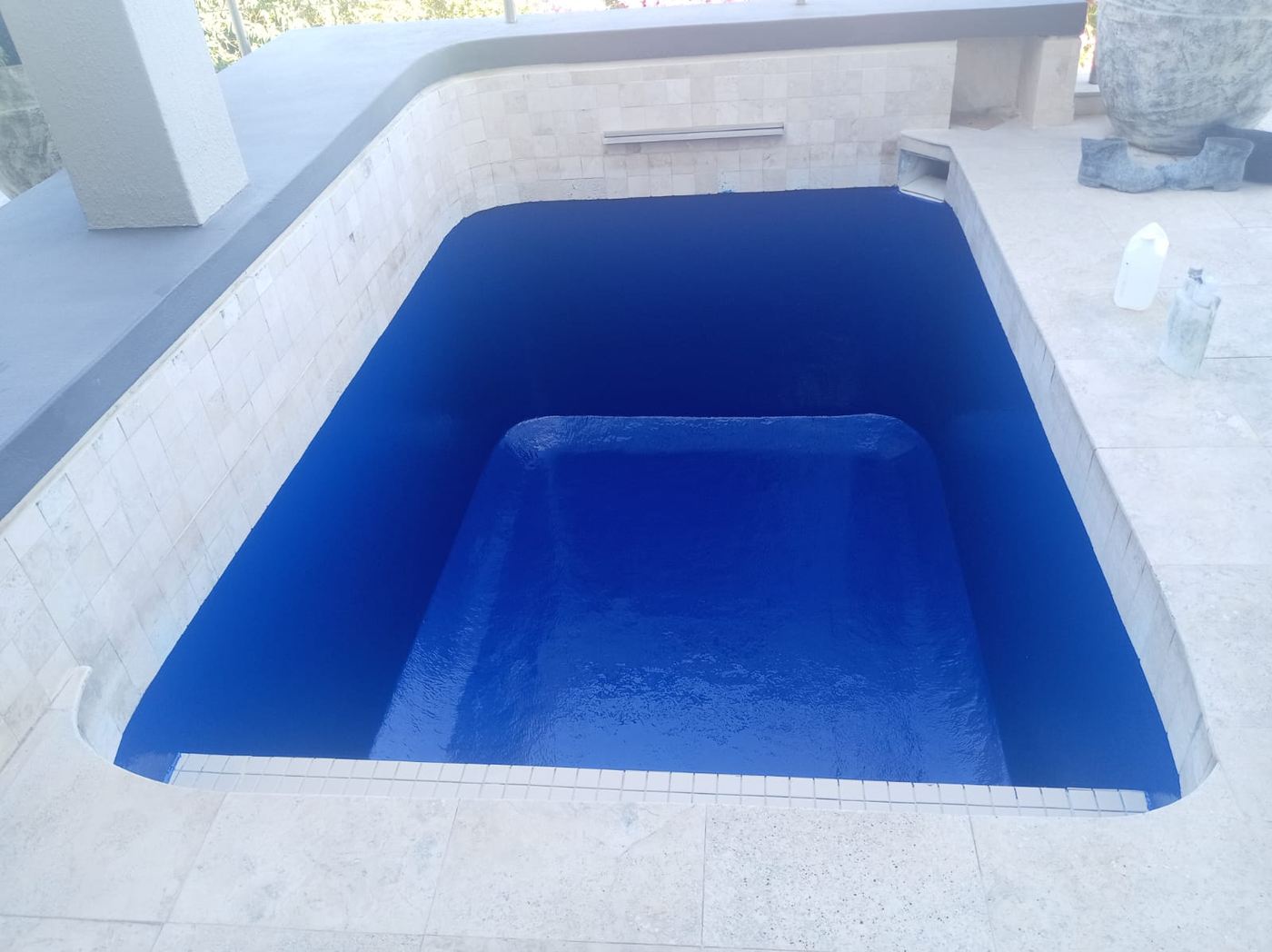 Deep blue plunge pool with a built-in bench
