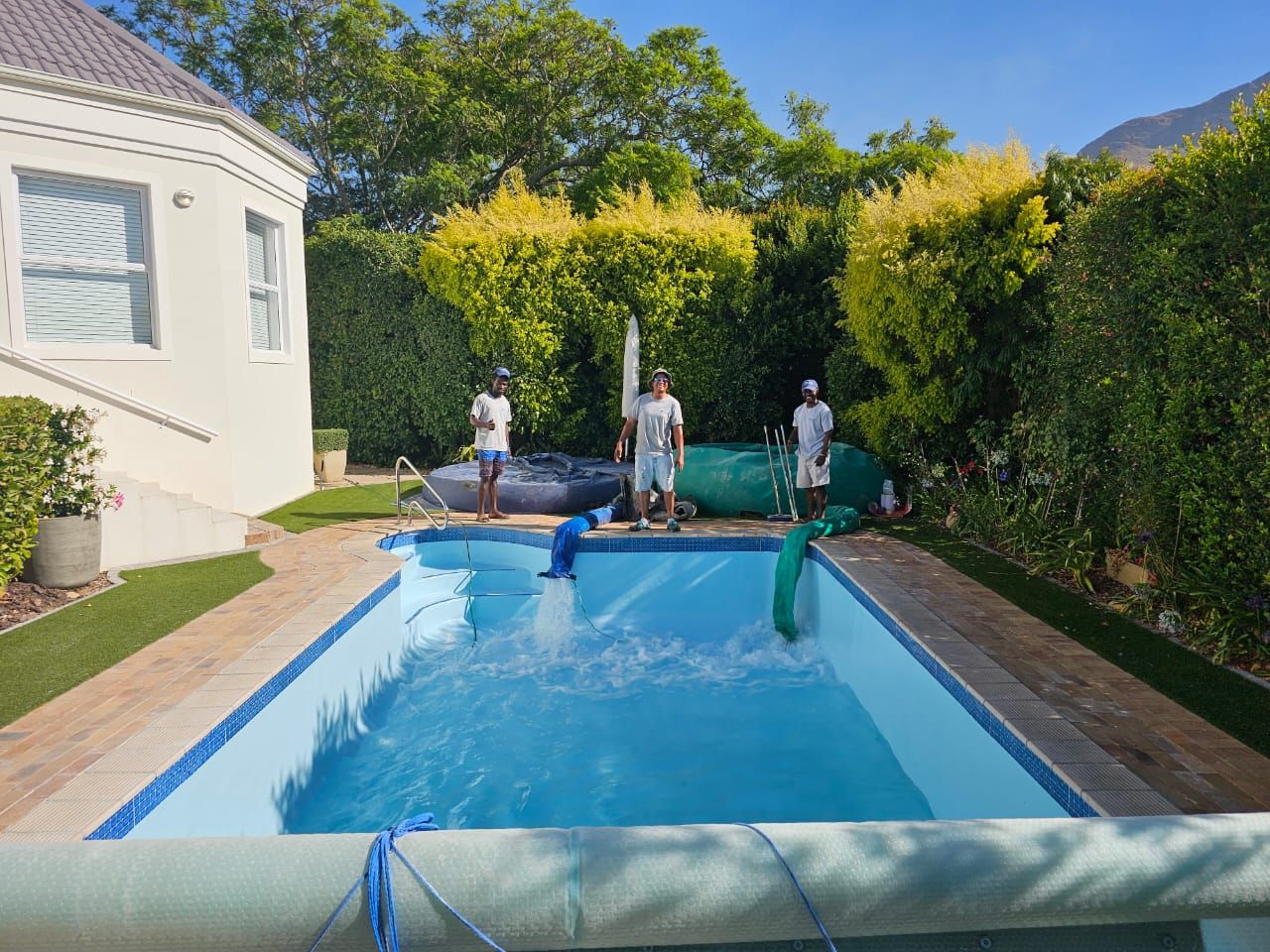 The Pool Crew team filling a freshly renovated pool