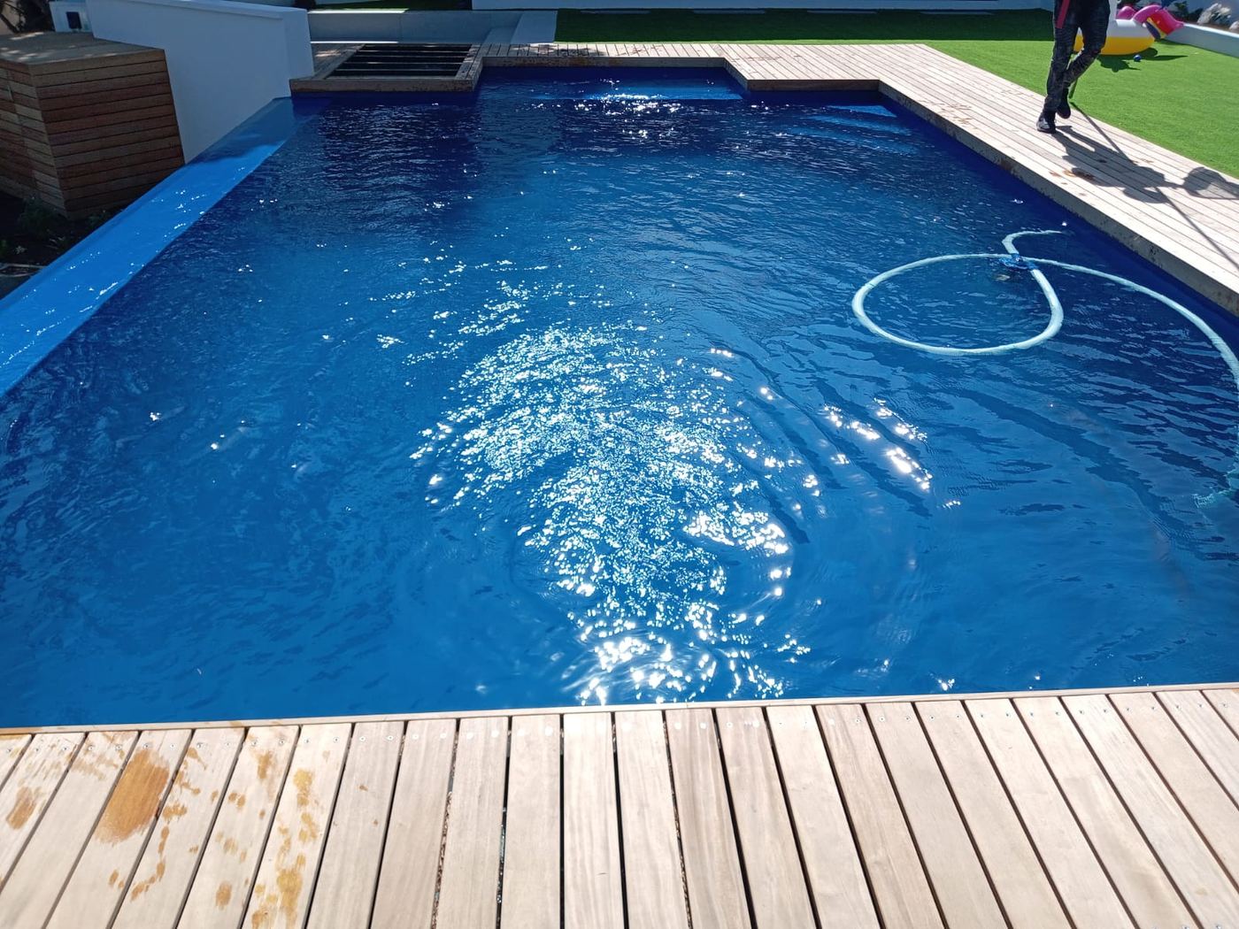 Royal blue swimming pool with timber decking